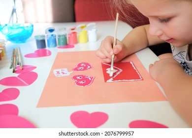 Child created homemade greeting card  A little girl painted   colored card and funny hearts  Gift for Mothers Day Valentines day  Arts   crafts concept 