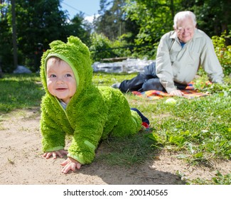 child creeps away from grandfather outdoors