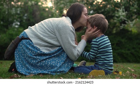 child is crying in park in arms of mom. Mommy soothes baby boy. family mother and child with tears in their eyes. emotionally. loving young mother hugs and soothes her little Son in Park. Motherhood - Shutterstock ID 2162124423