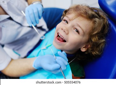 Child With Curly Hair At The Dentist