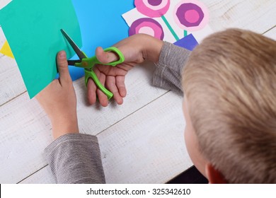 Child Cut Out Of Colored Paper. Kid Making  Birthday Card. Happy Mothers Day And Happy 8 March. Kids Art, Art Projects, Handmade New Year Decorations 