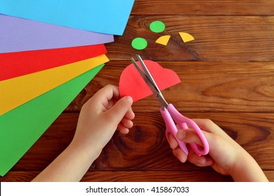 Child cuts a car out of paper. Sheets of colored paper. Kids art. Kids crafts. Crafts concept. How to make a greeting card father's day  - Powered by Shutterstock