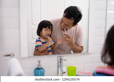 child with dad learn how to brush your own teeth on daily routine before bed - Powered by Shutterstock