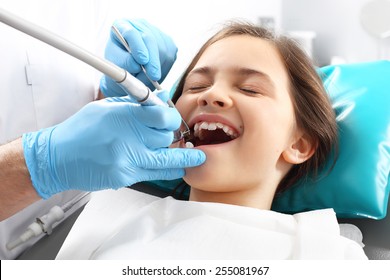 Child to the dentist. Child in the dental chair dental treatment during surgery.