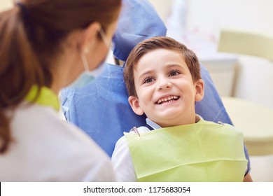 A child with a dentist in a dental office.  - Powered by Shutterstock