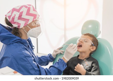 A Child With A Dentist In A Dental Office. Dental Treatment In A Children's Clinic.