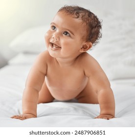 Child development, cute and smile with baby on bed in home for growth, having fun or playing. Adorable, balance and innocent with happy newborn infant learning to crawl in bedroom of apartment - Powered by Shutterstock