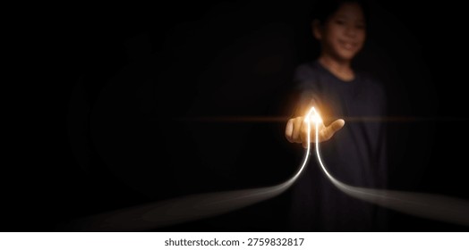 Child development and learning growth concept with upward arrow rising path. Girl pointing to growing direction on dark background. Education progress, development journey, personal growth, success.