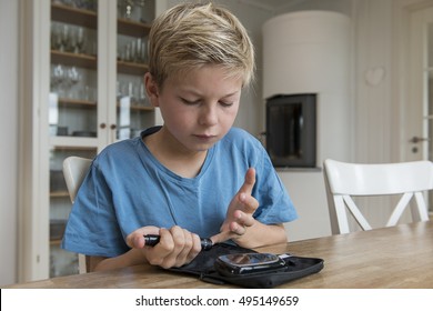 Child With Diabetes Measuring Glucose Or Blood Level In A Kitchen.