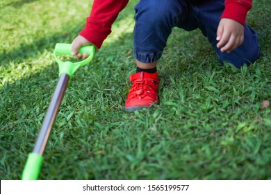 A Child Digging Soil On The Ground