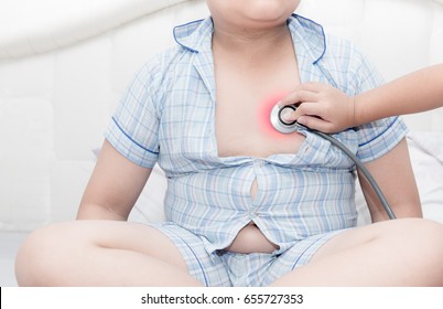 Child Doctor Check Heart By Stethoscope To Overweight Asian Boy, Healthcare Concept