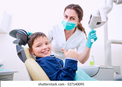 Child with doctor in the office shows thumb - Powered by Shutterstock