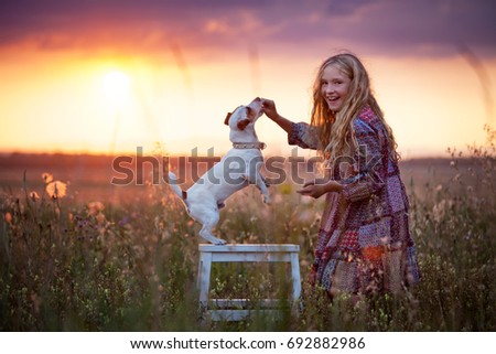 Similar – Image, Stock Photo Blond woman walking her dogs at sunset