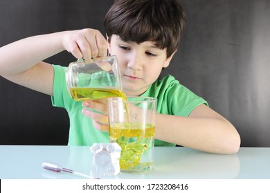 Child Doing An Experiment, A Lava Lamp With Water, Oil, Dye, And Effervescent Tablet