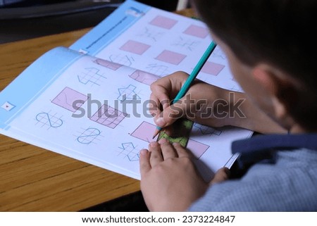 Child doing geometry school homework. Student in mathematics classes. Study and school concept.
