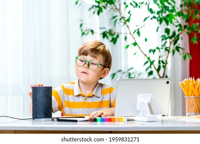 Child Doing Homework And Using Smart Speaker And Voice Assistant. Education Programme For Child. Boy Talking To Alexa And Give It Orders And Commands What To Switch On. Online Lesson.