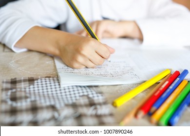 Child Doing Homework And Writing Story Essay. Elementary Or Primary School Class. Closeup Of Hands And Colorful Pencils.