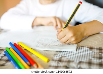 Child Doing Homework And Writing Story Essay. Elementary Or Primary School Class. Closeup Of Hands And Colorful Pencils. In German 