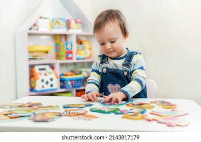 The child doing puzzle. Educational logic toys for kid's. Montessori Games for Child Development - Shutterstock ID 2143817179
