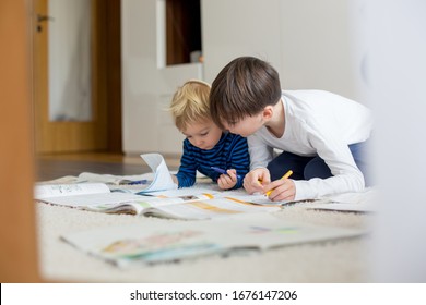 Child, doing school work on the floor at home while in quarantene, kid homeschooling