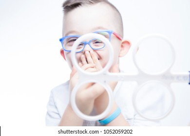 Child With Down Syndrome With Prism Flippers. Eye Vision Therapy.