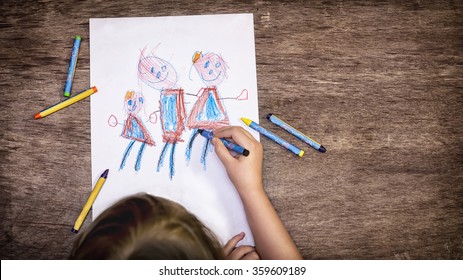 The Child Drawing A Family