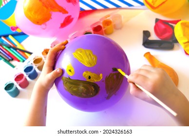Child drawing pattern of paints fun smile on the balloon. Fun toy. Arts  crafts concept. art learning and education