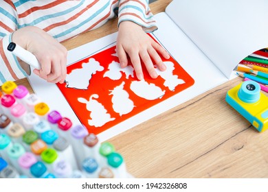 The child draws animals through a stencil. Toddler early preschool education. - Powered by Shutterstock