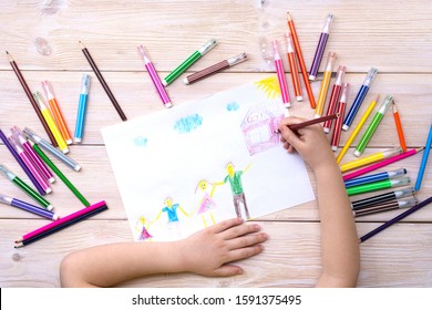 A Child Draws A Birthday Card With His Family. Drawing Made By A Child With Colorful Felt-tip Pens And Pencils. Happy Family. Child's Drawing