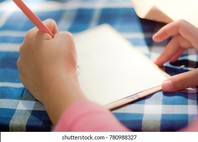 Child Draws Items On A Paper Card. On Sunny Day. 