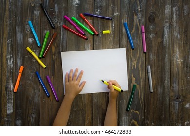 child draws in a notebook
