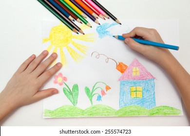 Child draws a pencil drawing of the world - Shutterstock ID 255574723