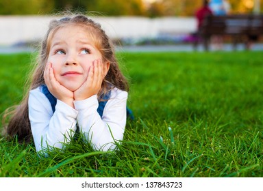 Child Dreaming On Green Grass