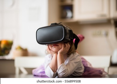 Child Dreaming With Virtual Reality Headset Indoors At Home