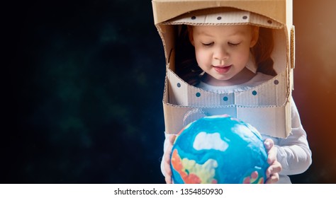 Child Is Dressed In An Astronaut Costume. Kid With Globe. Earth Day.