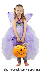 Child Dressed As A Fairy In A Homemade Costume For Halloween And Holding A Basket Of Candy. Isolated On A White Background.