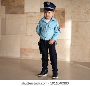 A Child Dressed As A Police Officer. The Holiday Of Purim Israel. Outdoor.