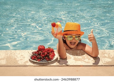 Child drink cocktail. Summer child by the pool eating fruit and drinking lemonade cocktail. Summer kids vacation concept. Little kid boy relaxing in a pool having fun during summer vacation. - Powered by Shutterstock