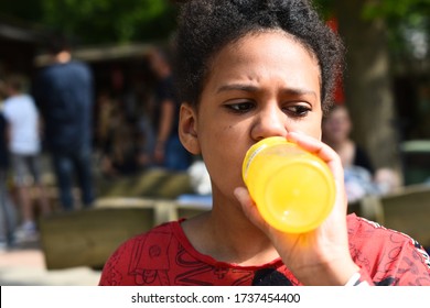 Child Drinking High Sugar Fizzy Drink Out Of Bottle 