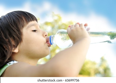 Child Drinking Pure Water In Nature