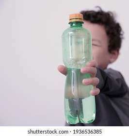 Child With Drinking Water In A Bottle With White Background Stock Photo