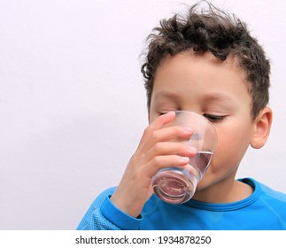 Child Drinking Water From A Glass With White Background Stock Photo