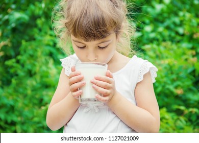 The Child Drinks Milk. Selective Focus.