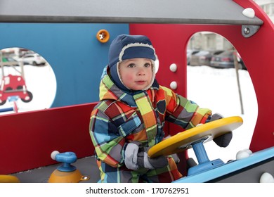 Child Driving In The Toy Car In Winter