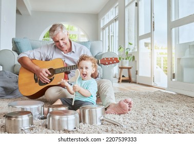 Child Drummer With Grandfather, Guitar And Music Playing With Pot Drums In The Living Room At House. Happy, Excited And Smile Of Boy Bonding And Spending Time With His Elderly Grandpa In Family Home.