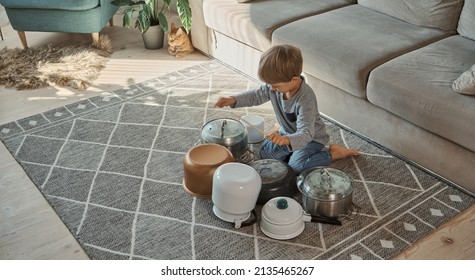 Child Drummer Having Fun Drum Playing On Kitchen Pans, At Home