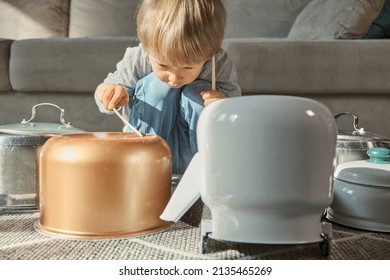 Child Drummer Having Fun Drum Playing On Kitchen Pans, At Home