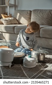 Child Drummer Having Fun Drum Playing On Kitchen Pans, At Home