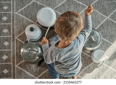 Child Drummer Having Fun Drum Playing On Kitchen Pans, At Home