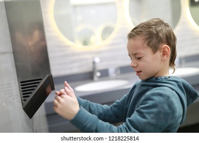 Child Drying His Hands In A Restroom